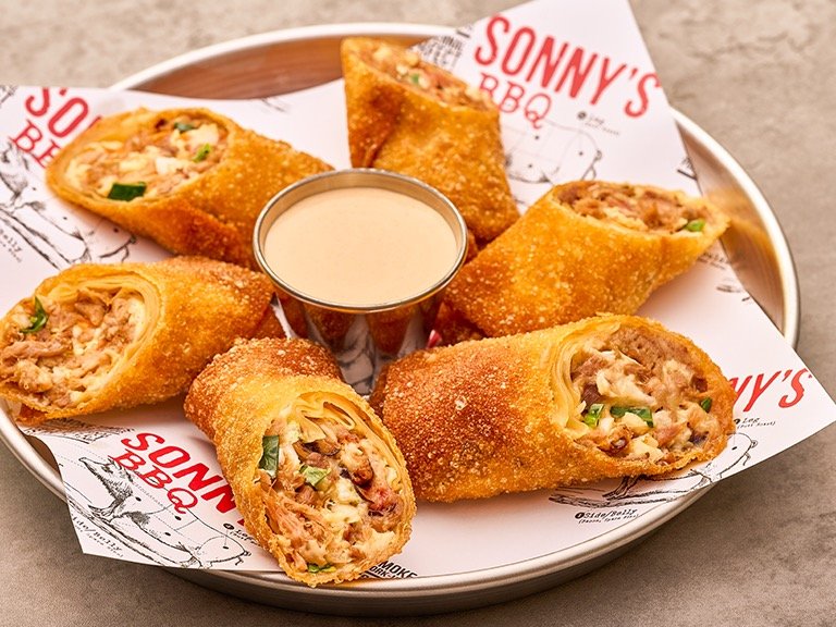 Crispy golden fried egg rolls stuffed with slow-smoked pulled pork, homemade coleslaw, and pepper jack cheese served with Smokin BBQ dipping sauce